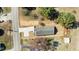 A high aerial view of a home with a large driveway and road frontage on a sunlit day at 5093 Nc 56 Hwy, Franklinton, NC 27525