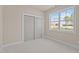 Bright bedroom featuring plush carpeting, a window, and a closet with sliding doors at 5093 Nc 56 Hwy, Franklinton, NC 27525