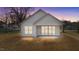 Back exterior of house with covered patio at dusk at 5093 Nc 56 Hwy, Franklinton, NC 27525