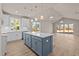 Bright, open kitchen featuring a blue island, pendant lights, stainless steel appliances, and hardwood floors at 5093 Nc 56 Hwy, Franklinton, NC 27525