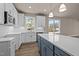 Bright kitchen showcasing white cabinets, a blue island, stainless steel appliances, and hardwood floors at 5093 Nc 56 Hwy, Franklinton, NC 27525