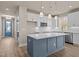 Stylish kitchen featuring a blue island with white countertop, stainless steel appliances, and white cabinets at 5093 Nc 56 Hwy, Franklinton, NC 27525