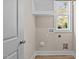 Neat laundry room featuring hookups, shelving, and a window for natural light at 5093 Nc 56 Hwy, Franklinton, NC 27525