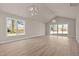 Open living space featuring wood floors, vaulted ceilings, modern lighting and a sliding glass door at 5093 Nc 56 Hwy, Franklinton, NC 27525