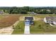 Aerial view of the home shows a large lot, mature trees, and a long driveway at 55 Diamond Creek Dr, Zebulon, NC 27597