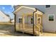 View of back porch with wood railing, steps, and light-blue vinyl siding under a blue sky at 55 Diamond Creek Dr, Zebulon, NC 27597