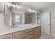 Bathroom with double sink vanity, quartz countertops, large mirror, and tiled shower at 55 Diamond Creek Dr, Zebulon, NC 27597