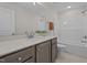 Bright bathroom with a single vanity, quartz countertop, and combined shower and tub at 55 Diamond Creek Dr, Zebulon, NC 27597