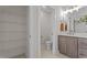 Neutral bathroom with vanity and linen closet at 55 Diamond Creek Dr, Zebulon, NC 27597
