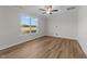Bright and airy bedroom featuring a large window and wood-look flooring at 55 Diamond Creek Dr, Zebulon, NC 27597