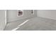 Bright bedroom with new carpet, white trim, and a view of the exterior through two windows at 55 Diamond Creek Dr, Zebulon, NC 27597
