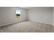 Cozy bedroom with neutral carpet, bright window, and fresh paint at 55 Diamond Creek Dr, Zebulon, NC 27597