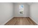 Bedroom with wood-look flooring and a bright window offering natural light and outdoor views at 55 Diamond Creek Dr, Zebulon, NC 27597