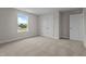 Bright bedroom with plush carpeting, a large window, and double door closet at 55 Diamond Creek Dr, Zebulon, NC 27597