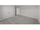 Bedroom featuring neutral carpeting, double door closet, and fresh paint at 55 Diamond Creek Dr, Zebulon, NC 27597