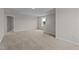 Large bonus room with neutral carpet, a window, and access to the hallway at 55 Diamond Creek Dr, Zebulon, NC 27597