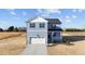 Charming two-story home with a front-facing garage and a welcoming front porch at 55 Diamond Creek Dr, Zebulon, NC 27597