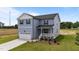 Charming two-story home featuring a covered porch, attached garage, and beautifully landscaped front yard at 55 Diamond Creek Dr, Zebulon, NC 27597