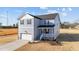 Charming two-story home with a front-facing garage and a welcoming front porch at 55 Diamond Creek Dr, Zebulon, NC 27597