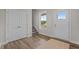 Inviting foyer with wood-look flooring, white trim, and natural light from the front door window at 55 Diamond Creek Dr, Zebulon, NC 27597