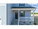 Close-up view of the front door and porch featuring stone accents and white railings at 55 Diamond Creek Dr, Zebulon, NC 27597