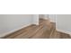 Hallway featuring modern wood-look flooring, white trim, and neutral-colored walls at 55 Diamond Creek Dr, Zebulon, NC 27597