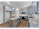 Stylish kitchen featuring granite countertops, blue cabinets, and stainless steel appliances at 55 Diamond Creek Dr, Zebulon, NC 27597