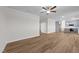 Open-concept living room and kitchen area with hardwood floors and modern lighting fixtures at 55 Diamond Creek Dr, Zebulon, NC 27597