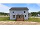 New construction home with a covered back porch and light blue siding at 55 Diamond Creek Dr, Zebulon, NC 27597
