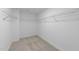 Walk-in closet with wire shelving and neutral carpeting, maximizing storage space at 55 Diamond Creek Dr, Zebulon, NC 27597