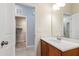 Bathroom with vanity sink, a large mirror, and a view into the walk-in closet at 809 Davidson Point Rd, Cary, NC 27513
