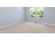 Bright bedroom with neutral carpet, blue walls, and natural light at 809 Davidson Point Rd, Cary, NC 27513