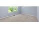 Bright bedroom features a large window with ample natural light and neutral carpeting at 809 Davidson Point Rd, Cary, NC 27513