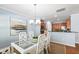 Elegant dining room featuring a glass table, stylish white chairs, and an open view into the kitchen at 809 Davidson Point Rd, Cary, NC 27513