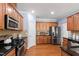 Spacious kitchen with stainless steel appliances, black countertops, and beautiful hardwood flooring at 809 Davidson Point Rd, Cary, NC 27513