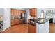 Well-appointed kitchen featuring stainless steel appliances, granite countertops, and wooden cabinetry at 809 Davidson Point Rd, Cary, NC 27513