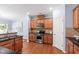 Kitchen featuring stainless steel appliances, black countertops, and stylish wooden cabinetry at 809 Davidson Point Rd, Cary, NC 27513