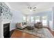 Cozy living room featuring a fireplace, ceiling fan, and comfortable seating at 809 Davidson Point Rd, Cary, NC 27513