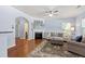 Spacious living room with a fireplace, ceiling fan, and access to the dining area at 809 Davidson Point Rd, Cary, NC 27513