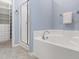 The main bathroom has a stand up shower and soaking tub near a walk in closet at 809 Davidson Point Rd, Cary, NC 27513