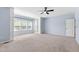 Main bedroom featuring plush carpeting, a ceiling fan, built-in shelving, and bright natural light at 809 Davidson Point Rd, Cary, NC 27513