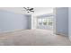 Spacious main bedroom with light blue walls, neutral carpet, ceiling fan, and built-in shelving at 809 Davidson Point Rd, Cary, NC 27513