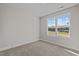Bright bedroom with neutral walls and carpeting, plus a large window at 22 Laramie Ln, Selma, NC 27576