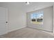 Cozy bedroom with neutral walls, plush carpet, and a bright window showcasing the exterior view at 22 Laramie Ln, Selma, NC 27576