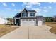 Beautiful two-story home with a three-car garage, modern siding, and a well-manicured lawn at 22 Laramie Ln, Selma, NC 27576