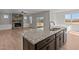 Stylish kitchen island features granite countertops and a stainless steel sink overlooking the living area at 22 Laramie Ln, Selma, NC 27576