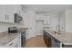 Modern kitchen with stainless steel appliances, granite countertops, and ample cabinet space at 22 Laramie Ln, Selma, NC 27576