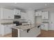Well-equipped kitchen featuring granite counters, a center island, and stainless steel appliances at 22 Laramie Ln, Selma, NC 27576