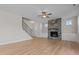 Cozy living room featuring a stone fireplace, staircase, and light hardwood floors at 22 Laramie Ln, Selma, NC 27576