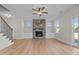 Inviting living room with stone fireplace, light hardwood floors and large windows at 22 Laramie Ln, Selma, NC 27576